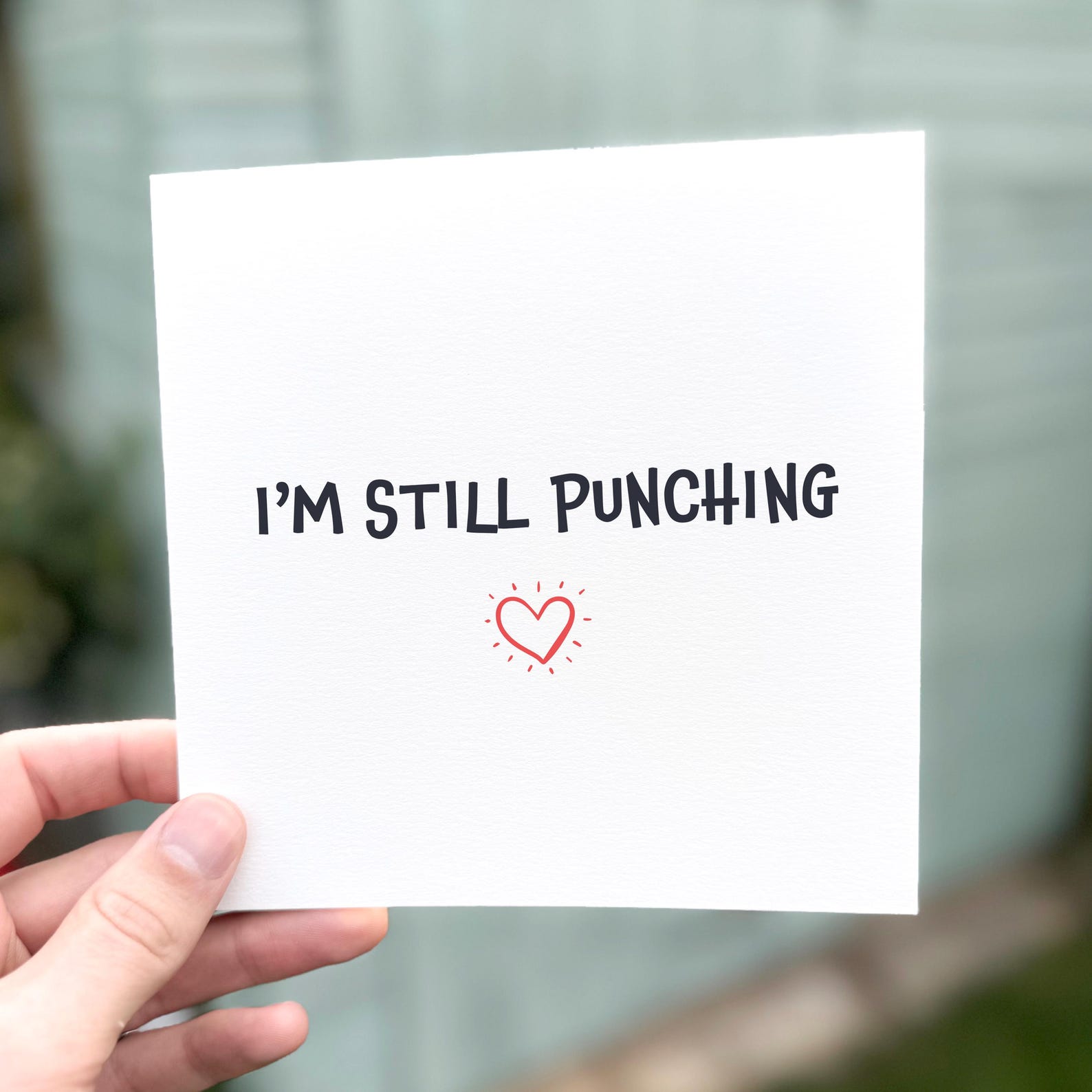 Funny romantic card featuring the phrase ‘I’m Still Punching’ with a red heart design.