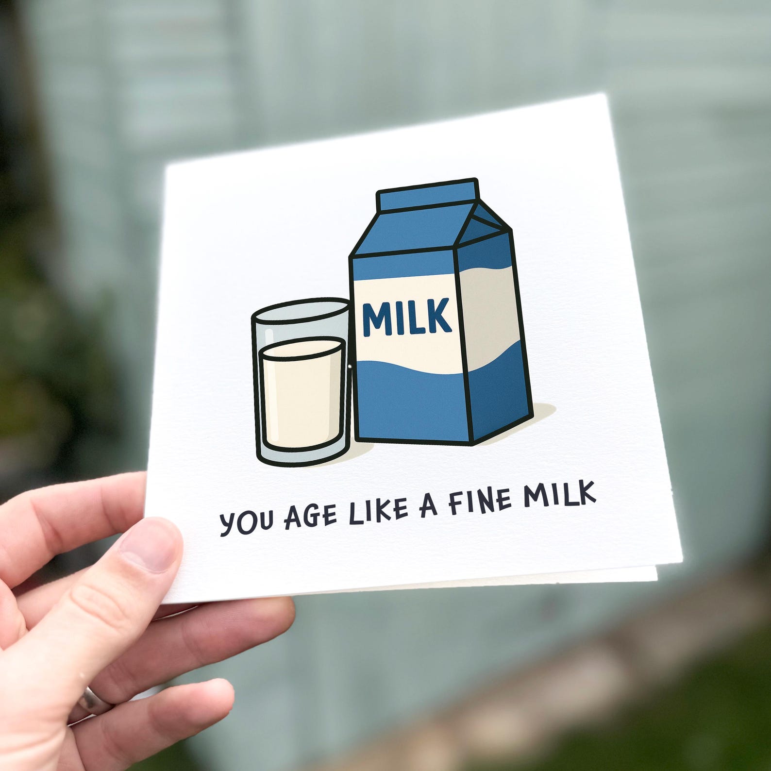 Funny birthday card featuring a cartoon milk carton and glass with the text ‘You age like a fine milk’.