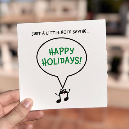 Festive card featuring a smiling musical note character saying ‘Happy Holidays’.