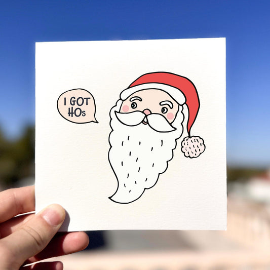Funny Christmas card featuring a cartoon Santa with the speech bubble ‘I Got HOs’.