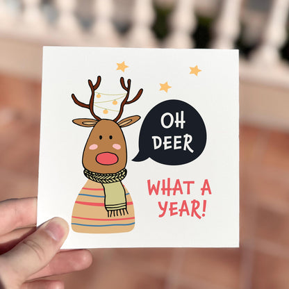 Funny Christmas card featuring a reindeer tangled in lights saying ‘Oh Deer What A Year’.
