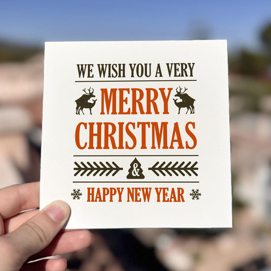 Classic Christmas card featuring bold typography and reindeer silhouettes with the text ‘Merry Christmas & Happy New Year’.