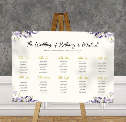purple lavender wedding Table Plan on a brown easel in a stylish room in a wedding venue