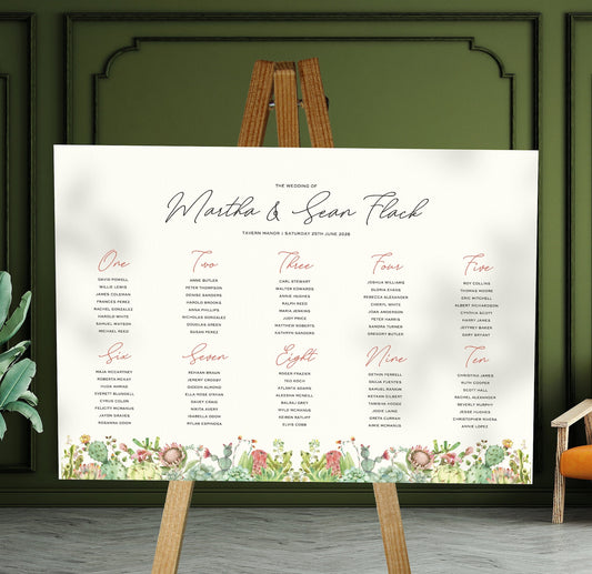 succulent and cactus wedding Table Plan on a brown easel in a stylish room in a wedding venue