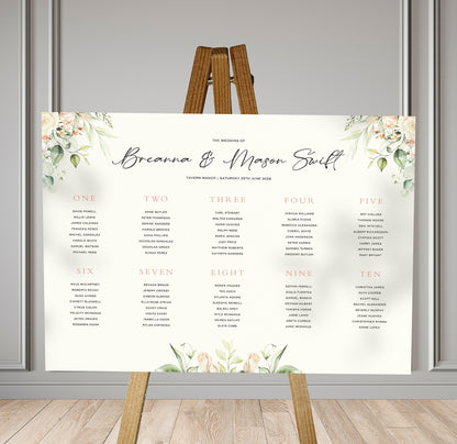 summer garden florals wedding Table Plan on a brown easel in a stylish room in a wedding venue
